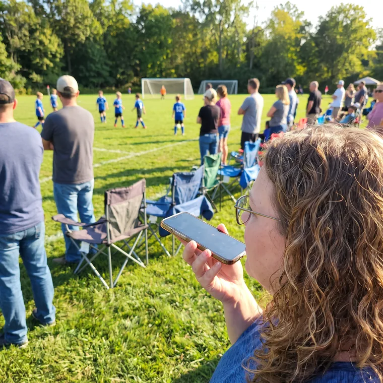 Working from a phone on the sideline of a kids game